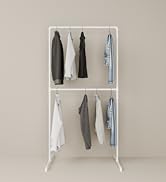 pamo white LAS clothing rack with clothes on beige background