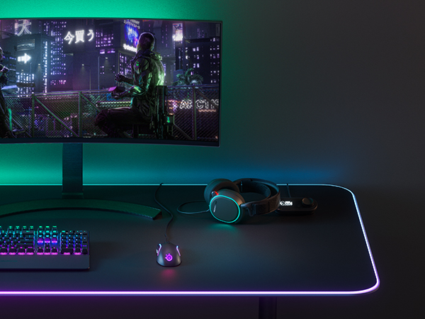 -SteelSeries desk setup with keyboard, mouse, headset, mousepad, and monitor