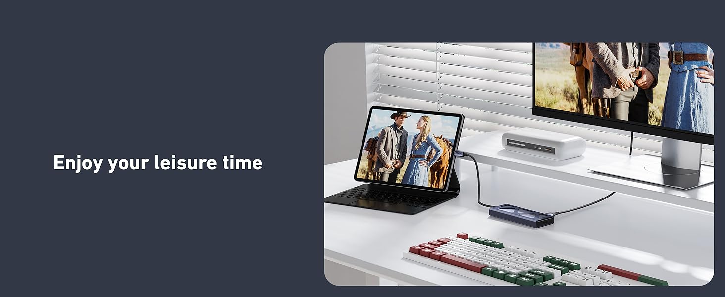 Text reads 'Enjoy your leisure time'. Shows desktop setup with computer monitor, keyboard, and various accessories in an office environment.