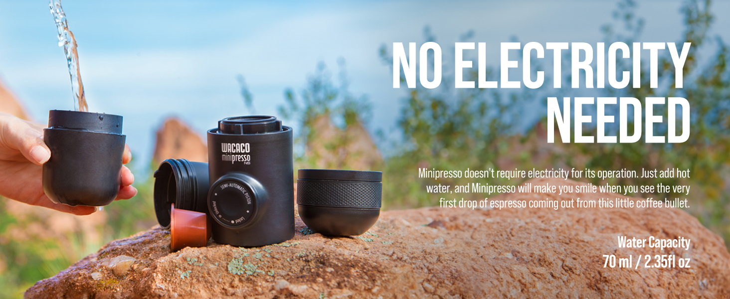Portable black coffee maker or brewing device shown outdoors on dirt ground, with text indicating no electricity required. 70ml/2.35fl oz capacity.