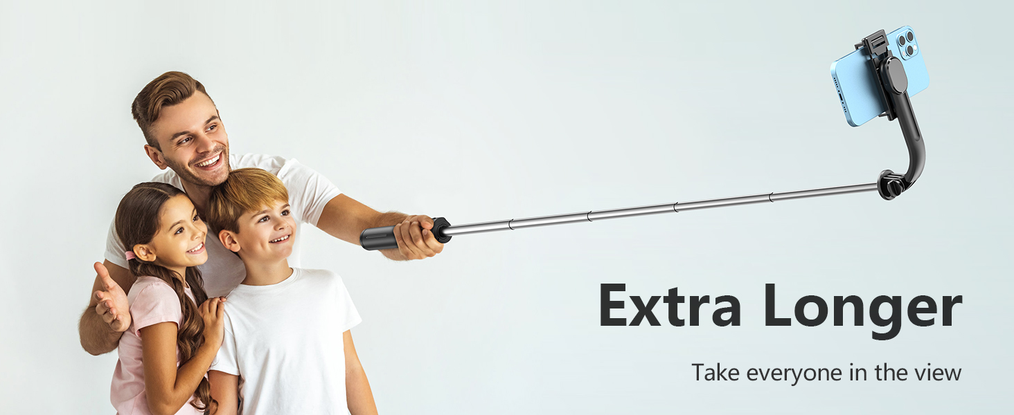 Extendable selfie stick with 'Extra Longer' text, held by a person taking a group photo with two others.
