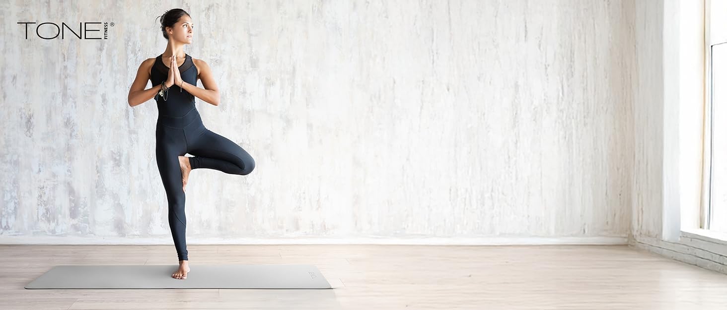 woman doing a yoga pose in a home studio workout space