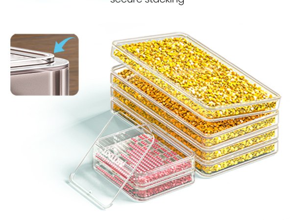 Stackable clear plastic storage containers filled with yellow and pink items. One container's lid is partially open, demonstrating a hinged design for easy access.