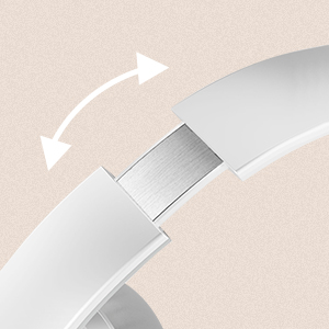 Close-up of a white or silver device showing an articulating or adjustable joint with directional movement arrows against a beige background.