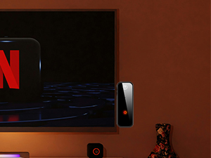 C28 in TX mode plugged into TV headphone jack; AirPods receive audio in dark room.