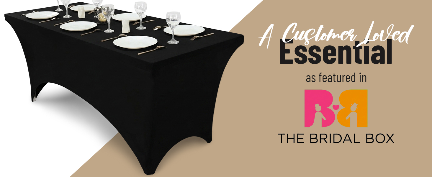 Text reads 'essential' and 'as featured in' and 'THE BRIDAL BOX'. Black spandex stretch table cover with multiple small bottles and products displayed on tan beige background.