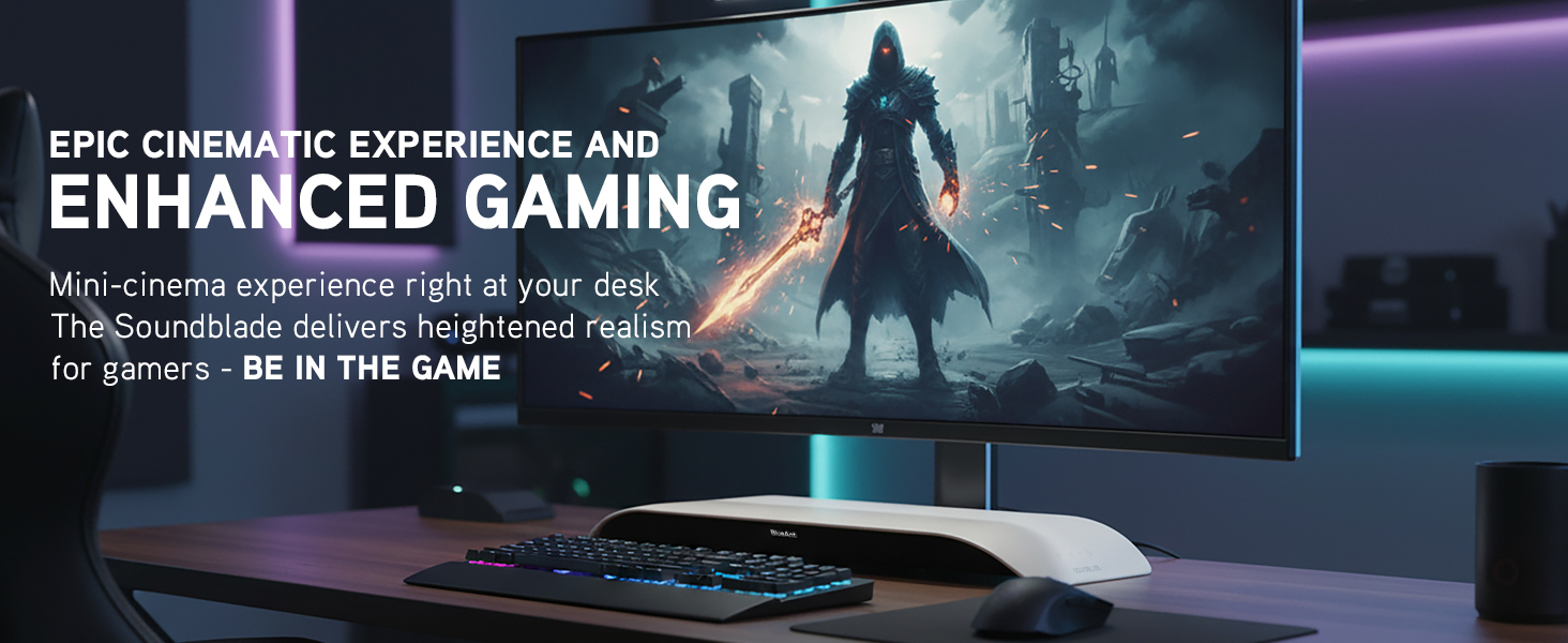 Gaming desk with widescreen monitor, RGB lighting and SoundBlade soundbar creating a cinematic setup