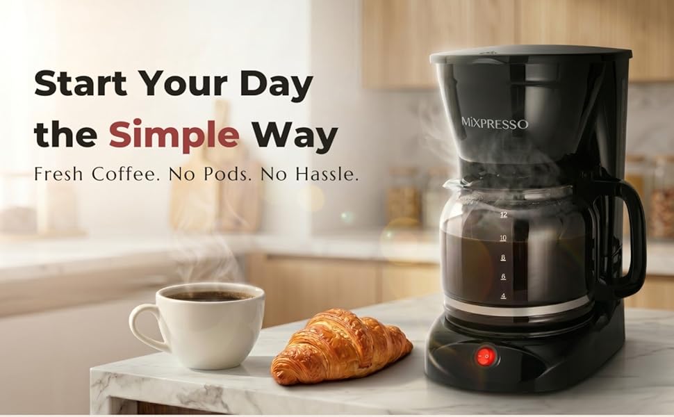 Drip coffee maker with glass carafe brewing fresh coffee on kitchen counter