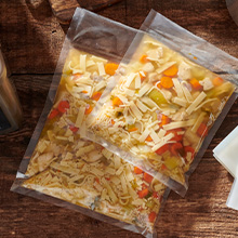 LEM vacuum sealer bags in two sizes holding sealed soup for storage