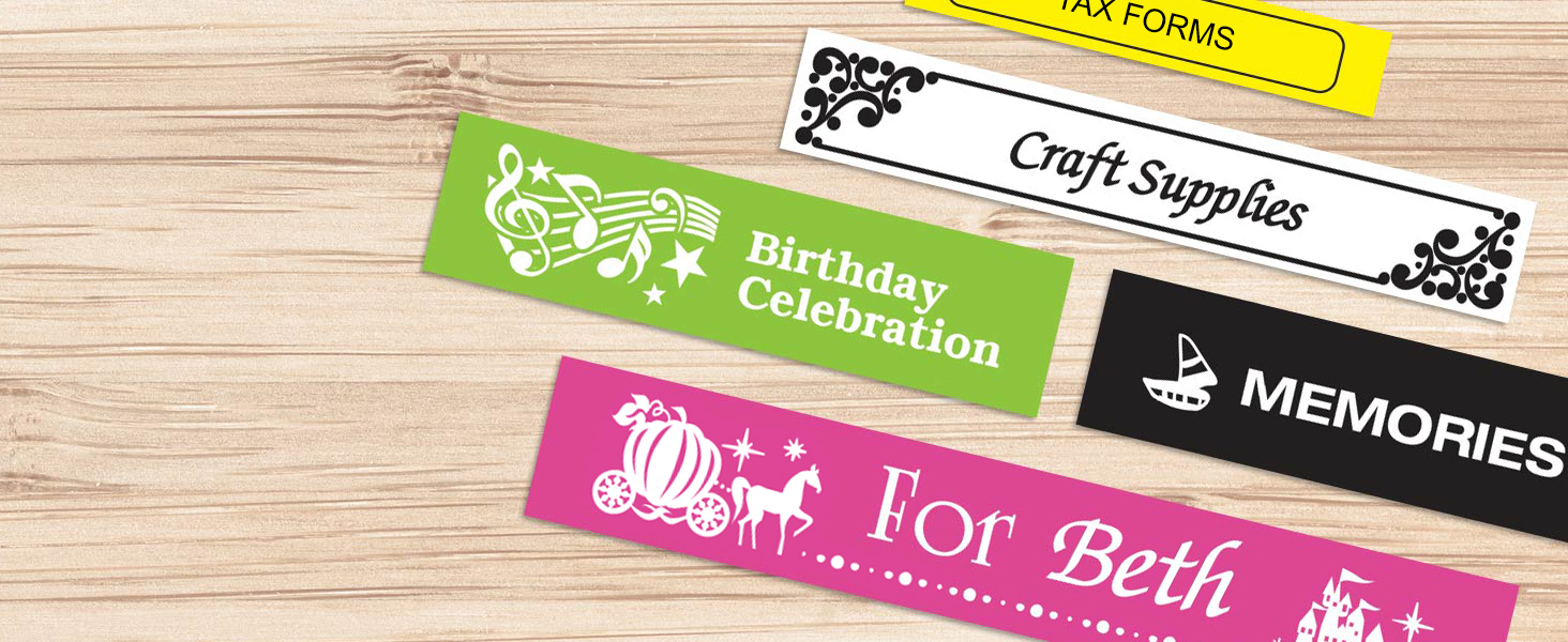 Different colored sample labels on a wood surface, with different fonts, symbols, and borders used