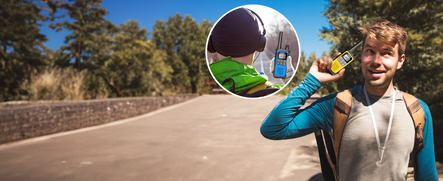 Hiker using long range walkie talkies in forest talking to long distant friend