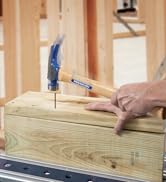 Vaughan hammer nailing nail into two 2x6 planks