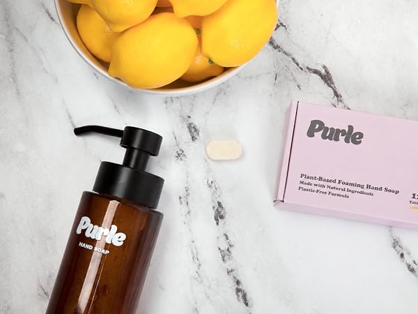 Purle foaming hand soap tablet, dispenser and packaging on marble countertop