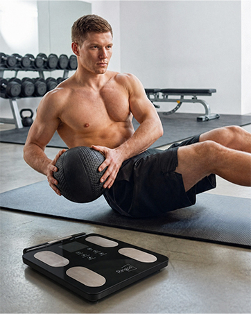 A man is warming up on a mat.