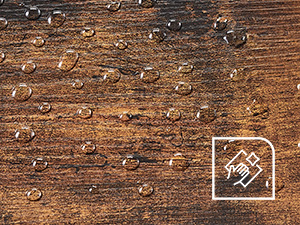 Close-up texture of weathered wooden surface showing natural grain patterns and rough, rustic appearance with varying brown tones.