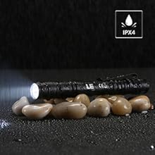 a black flashlight with a light shining through it.