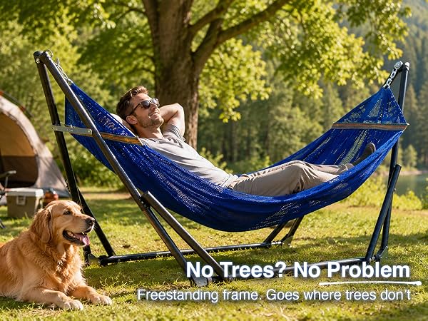 Portable hammock needs no trees, set up at campsite with man relaxing with pet dog