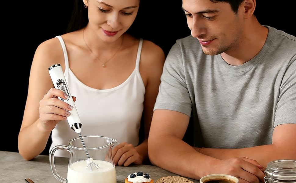 Portable handheld milk frother making rich foam in a coffee cup, perfect for home and office use.