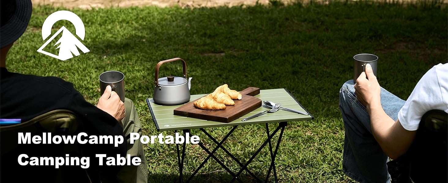 Adults enjoy lakeside picnic with a portable foldable camping table holding croissants and teapot