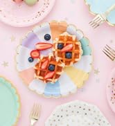 Colorful segmented paper plates with gold foil edges and waffles for vibrant party celebrations.