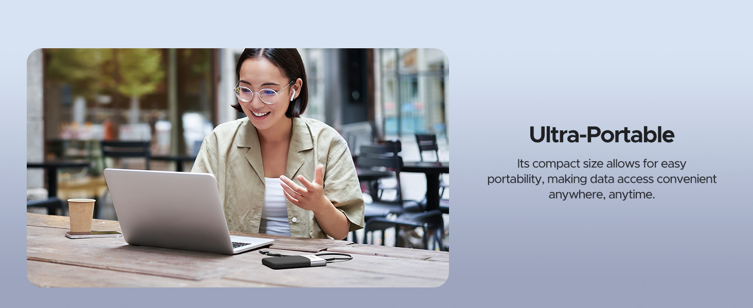 Woman using laptop at outdoor cafe. Text overlay describes product as 'Ultra-Portable' for convenient access anywhere, anytime.