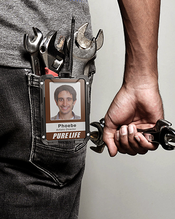 The scene of the mechanic wearing a badge holder on his trouser back pocket.