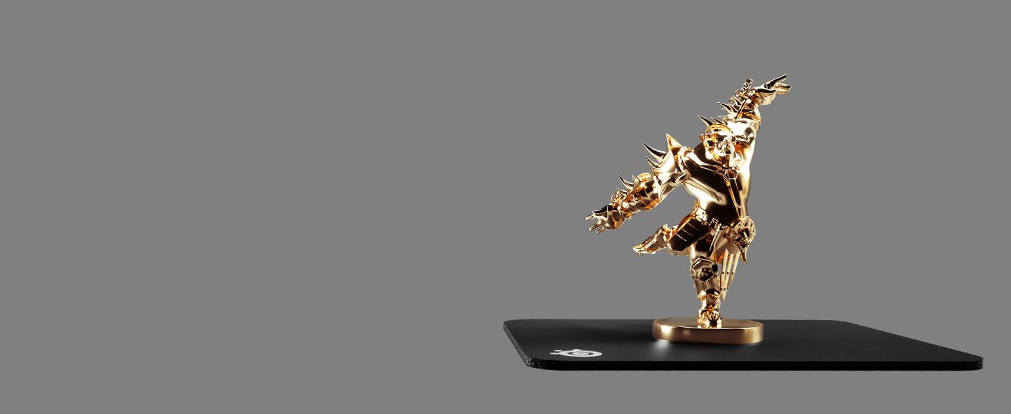 -Golden orc trophy on top of SteelSeries QcK mousepad