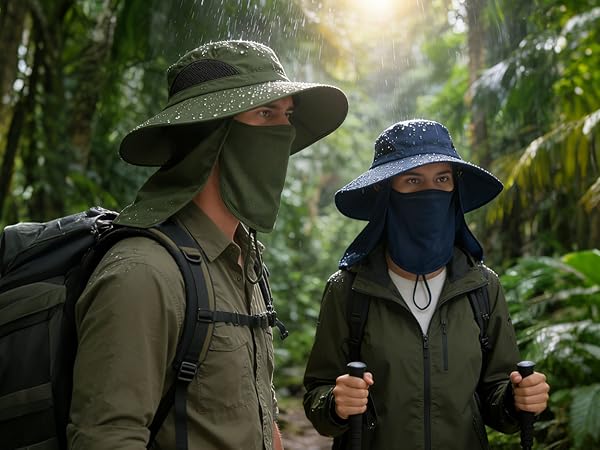 Jungle hikers in rain: Man (green), woman (navy). Backpacks, foliage. Water-resistant hats.