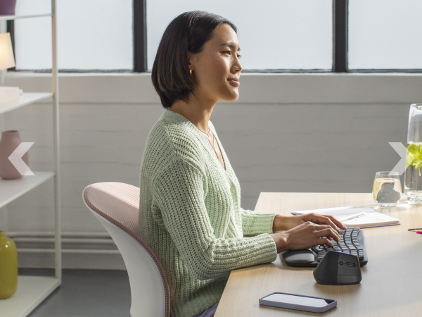 a woman typing on wave keys wireless ergonomic compact keyboard