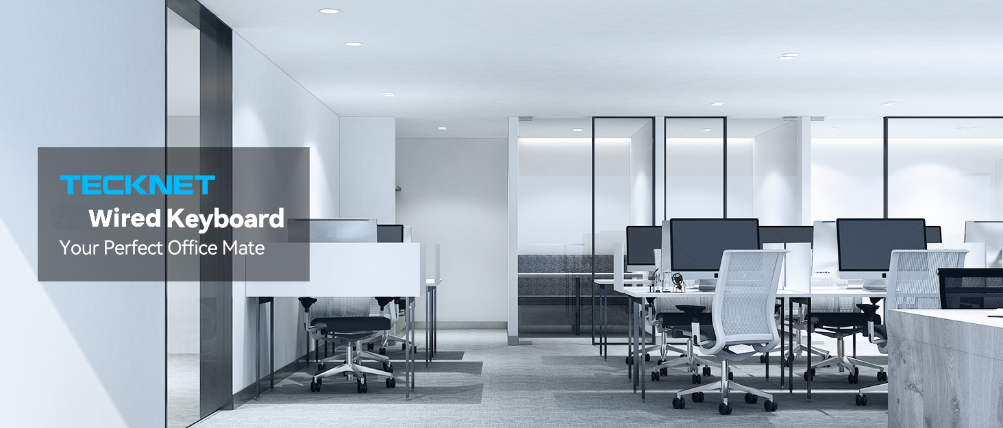 Text reads 'Wired Keyboard'. Modern office space interior with desks and equipment, featuring blue-tinted lighting.