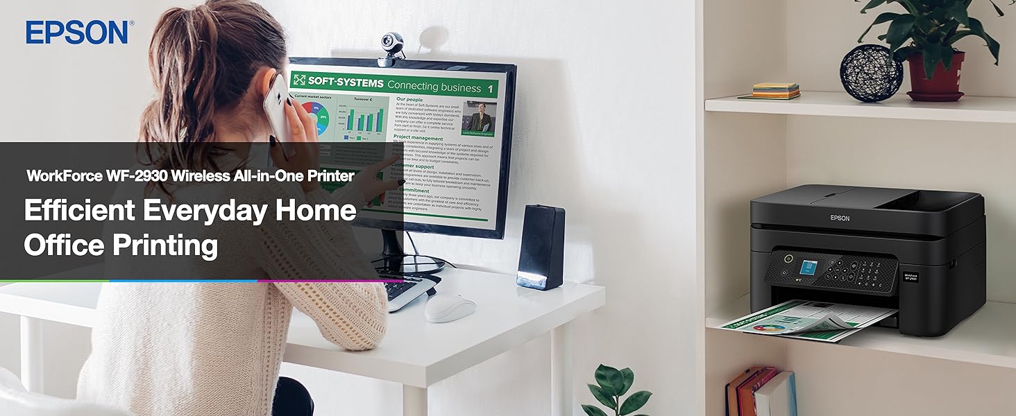 Person working at desk with black WorkForce WF-2930 printer sitting on nearby bookshelf.