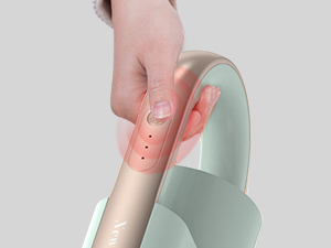Close-up of hands applying or peeling a peach-colored material onto a mint green surface.