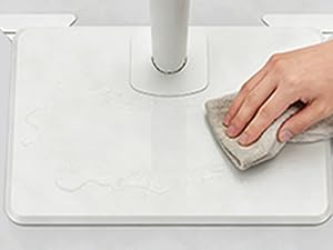 Sequential demonstration images showing hands interacting with a white electronic device or surface, demonstrating proper usage steps.