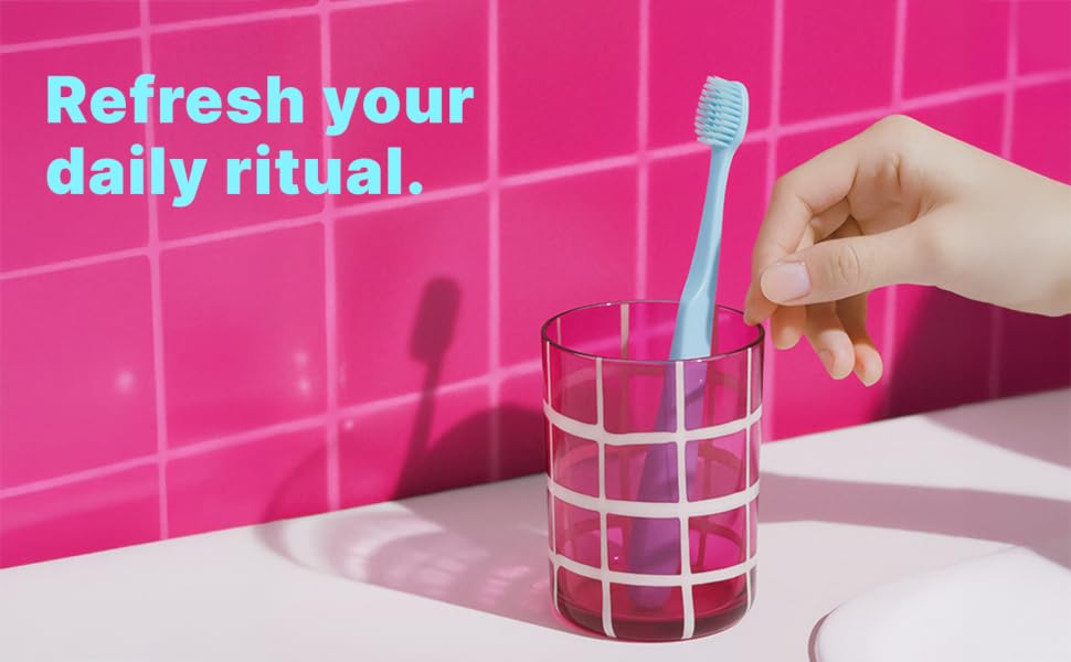 Person using Tonochi soft bristle toothbrush during daily oral care routine.
