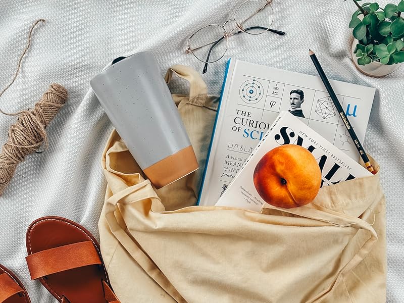 overcast grey travel mug with peach books shoes bag