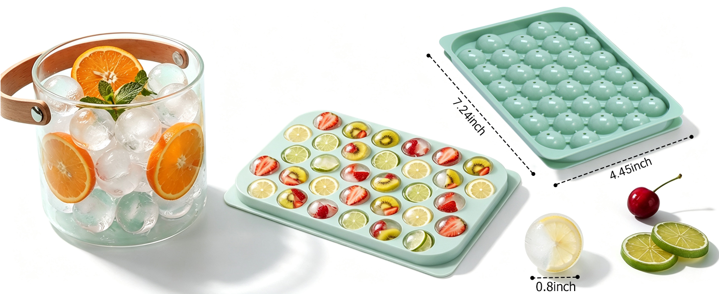 An ice tray sits on the table, next to a small bucket filled with ice and oranges.