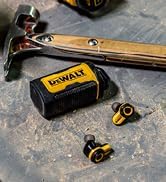 Workshop bench setting with scattered metallic components and a measuring tool on wooden surface.