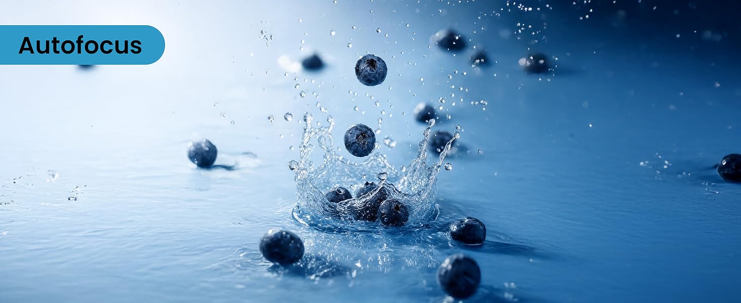 Text reads 'Autofocus' on blue label. Fresh blueberries suspended in water splash against deep blue background, showcasing dynamic product photography.