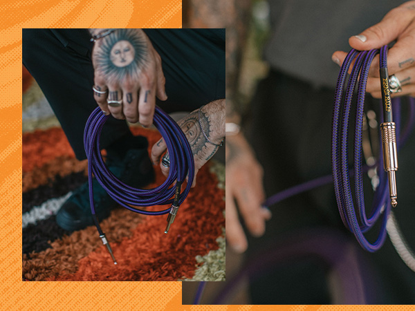 hand holding purple guitar cable
