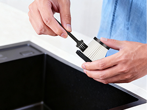 2.Gently brush away dust and grit from the HEPA filter with a small brush