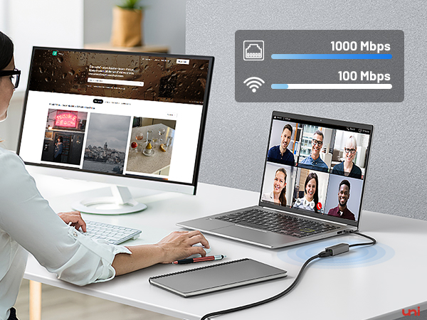 a person sitting at a desk with a laptop and a tablet.