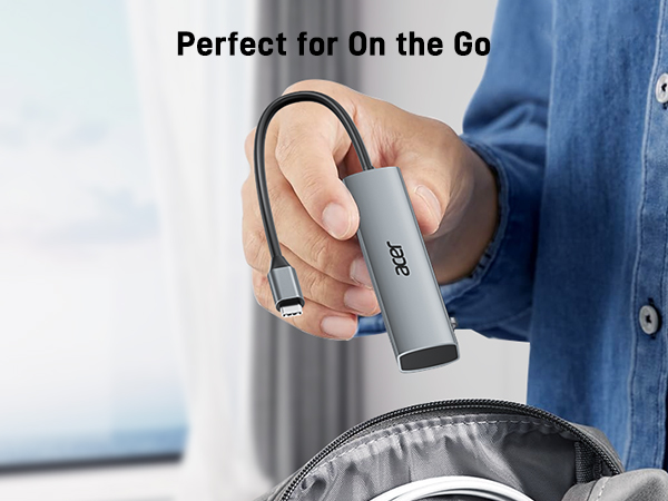 Hand holding a compact silver device with USB connector, demonstrating its portability. Text suggests it's suitable for on-the-go use.