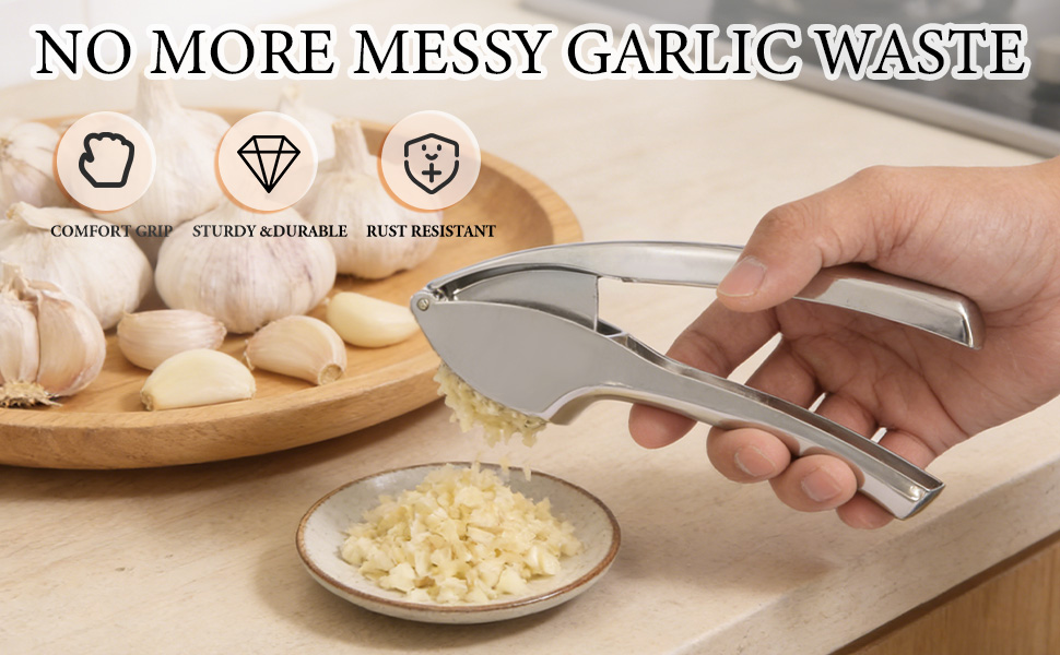 The garlic press is in the process of crushing garlic