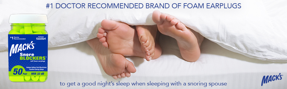 Happy couple sleeping soundly in bed with snoring earplugs. Only their intertwined feet are visible.