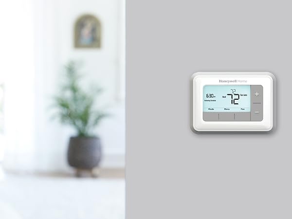 RTH7560E Thermostat on wall in bedroom