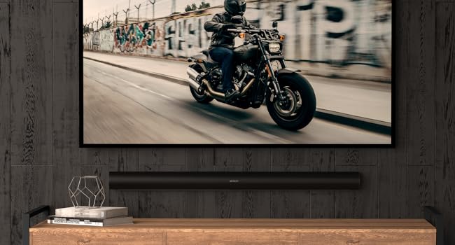 Sonos Arc wall mount under tv, black motorcycle on TV