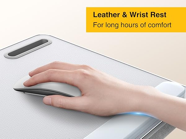 Hand resting on leather wrist pad while using wireless mouse on ergonomic lap desk.