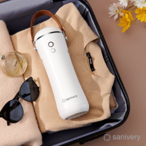 The product is sitting in a opened suitcase with clothes