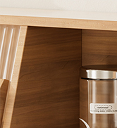 Partial view of a wooden cabinet or shelf with a silver cylindrical container visible.