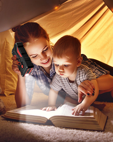 Cozy scene of reading under blanket fort with warm lighting, showing open book illuminated by flashlight.